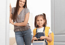Image: A mom looks on as her daughter walks out the door, ready for school (School Mornings: 11 Hacks to Make Them Easy (Ok, "Easier") Candice Carricarte Contributor Miami Mom Collective)