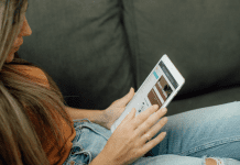 Image: Woman sitting and reading on her tablet (Top 10 Blog Posts of 2021 Lynda Lantz Editor Miami Mom Collective)