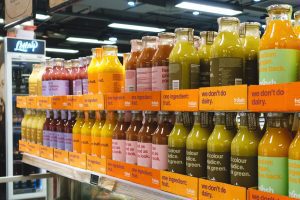 Image: Bottled fruit and veggie beverages on a grocery store shelf (Monica Moreno Contributor Miami Mom Collective)