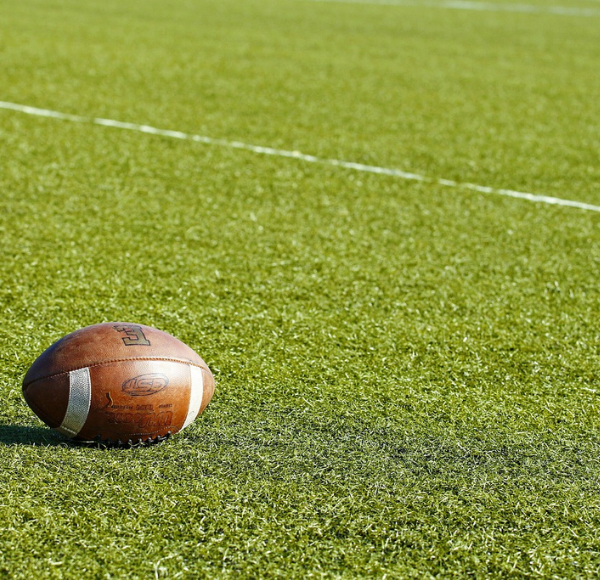 Image: A football on the field (The Big Game 2022: Gear Up for Football, Snacks, and Fun! Dianna Hill Contributor Miami Mom Collective)
