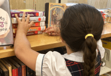 Image: A child looks for books at a local library