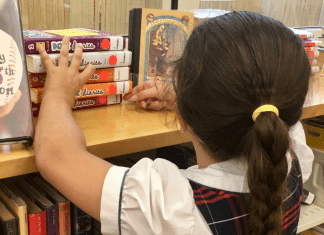 Vanessa's daughter looks for books at a local library