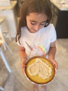 Rachelle's daughter holding the coconut key lime pie she made