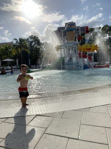 A toddler play in the zero-entry pool at Tidal Cove Water Park