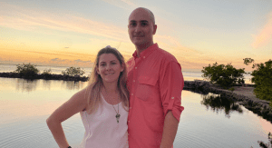 Grettel and her husband, backed by a Miami sunset