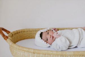 A newborn baby in a basket