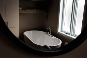 A standalone bathtub by a window