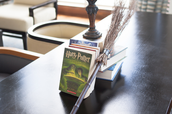 A centerpiece of Harry Potter books and a wooden broom