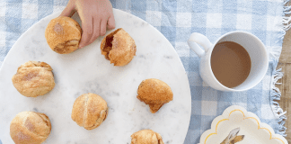 Child's hand taking a Resurrection Roll off of a plate to enjoy