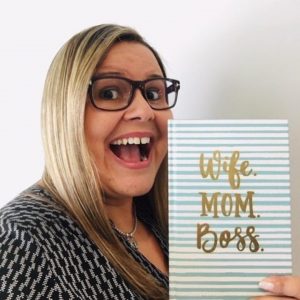 Vanessa, holding a journal that reads "Wife. Mom. Boss." In this post she shares her favorite stress-busting tips.