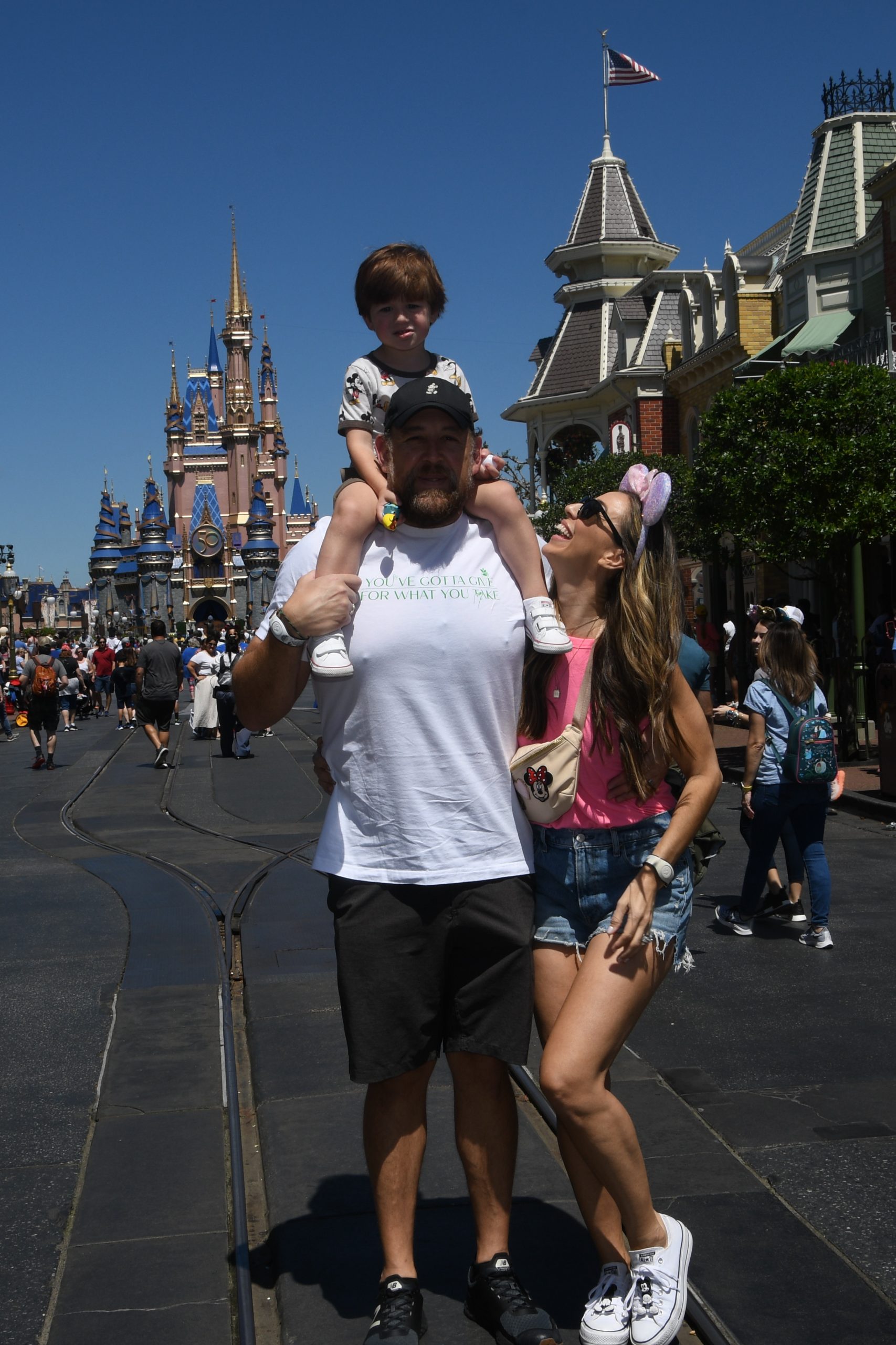 A family poses for a picture at the Magic Kingdom