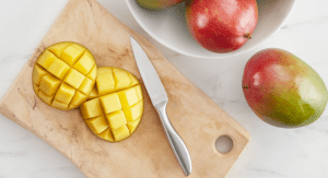 Image: A sliced mango on a wooden cutting board