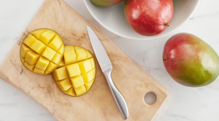Image: A sliced mango on a wooden cutting board