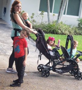 A mom out for a walk with 4 kids