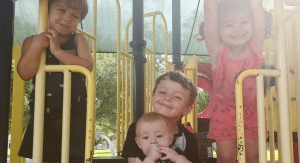 Four kids enjoying a playground at a public park