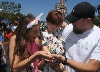A family poses for a picture with Tinkerbell at Disney's Magic Kingdom