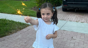 Image: A little girl holding a sparkler
