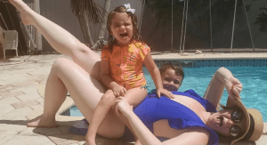 A woman with kids by the pool, embracing her summer beach body