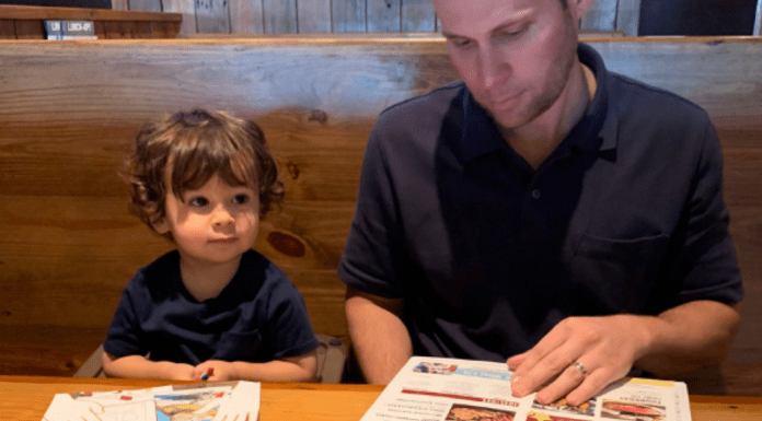 Ana-Sofia's husband and son looking at menus at Miller's Ale House