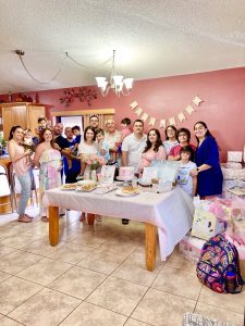 Family gathered at a baby shower for Rachel and her husband