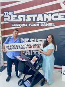 The Solano family in front of a Resistance-themed banner