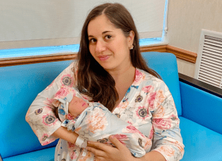 Rachel, holding her newborn daughter