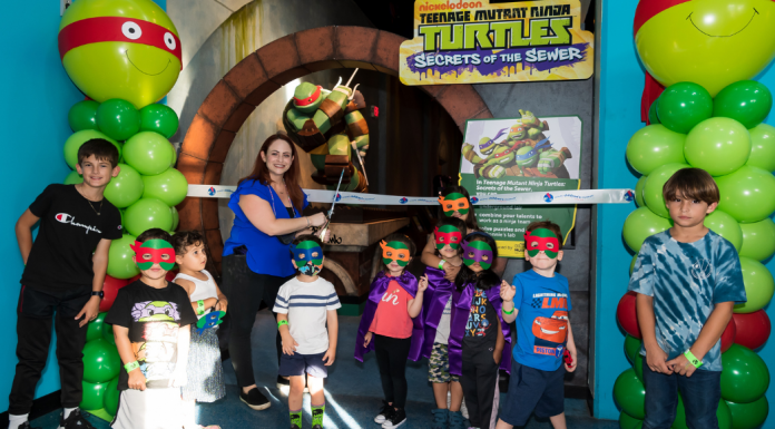 Several children participate in the ribbon cutting ceremony at Miami Children Museum's TMNT Secrets of the Sewer Exhibit