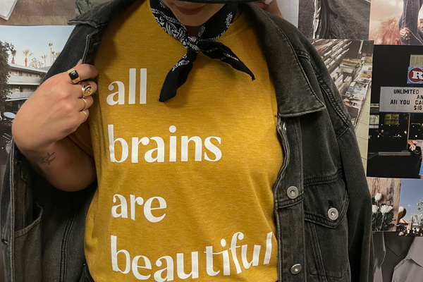 Jacqueline modeling a t-shirt that reads, "All brains are beautiful."