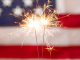Image: Sparkler fireworks with an American flag in the background