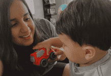 Daniella and Enzo playing with a red car.