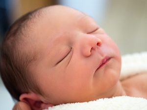 A sleeping newborn infant