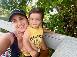 Daniela and her son pose for a selfie in the shade
