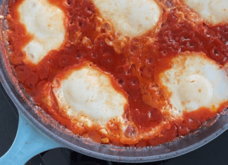 A pan of marinara sauce and mozzarella cheese