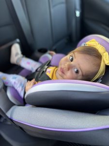 child safely strapped in car seat