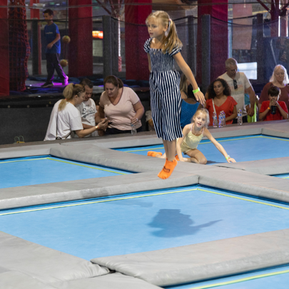 A girl jumps on a trampoline at Dezerland Park