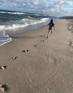 A little girl running on the beach