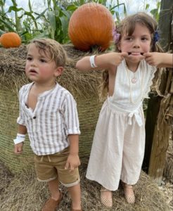A brother and sister enjoying a local pumpkin patch
