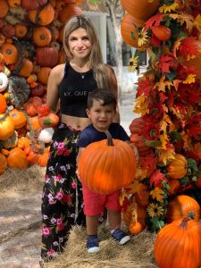 Bella and her son post for a fall photo with the decorations on Giralda in Coral Gables