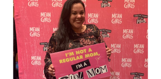 Image: Krystal holding a sign that reads, "I'm not a regular mom, I'm a cool mom."