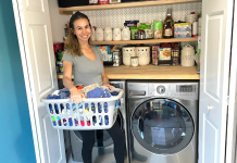 Image: Jessica stands in front of her washer and dryer with a basket of laundry
