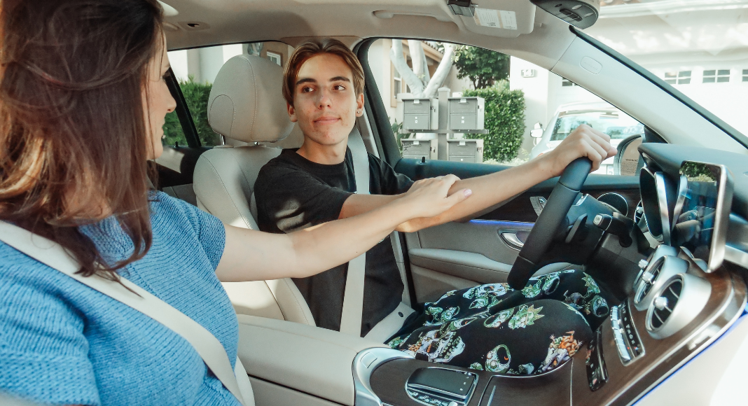 Image: Mom teaching teenage son to drive