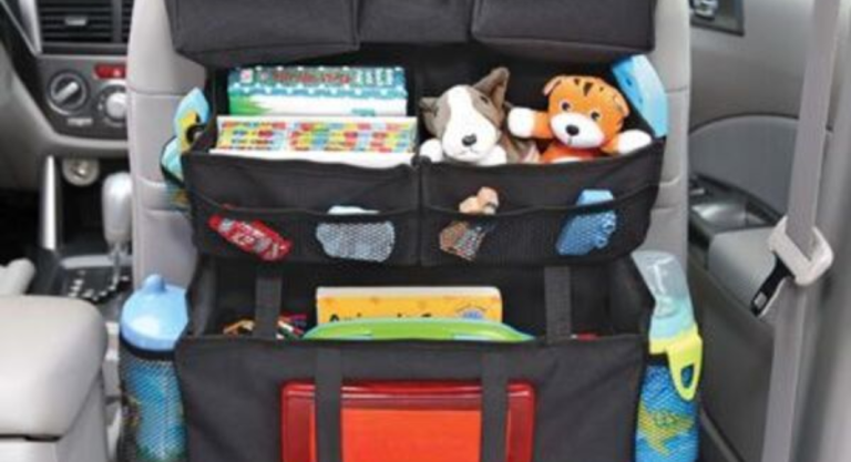 Image: A seatback organizer with water bottles, toys, and other essentials for the car