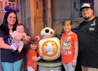 Image: A family poses for a photo with BB-8
