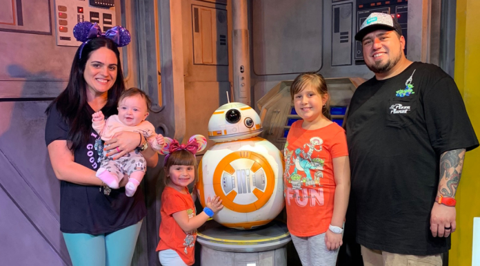 Image: A family poses for a photo with BB-8
