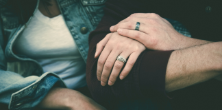 Image: A married couple sitting together, arm in arm