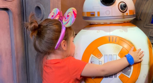 Image: A little girl hugs BB-8 at Disney World