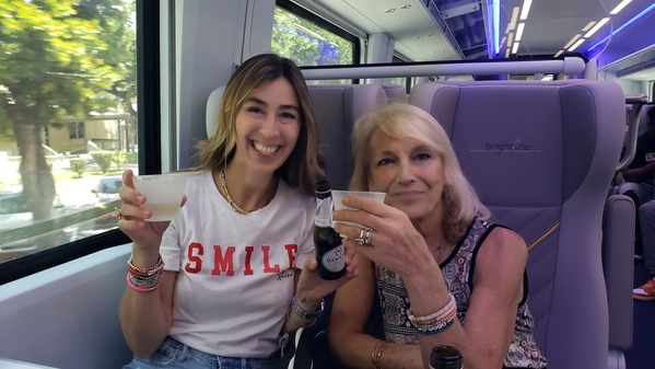 Image: Sandra and her mom toast their mimosas as they enjoy a right on Brightline