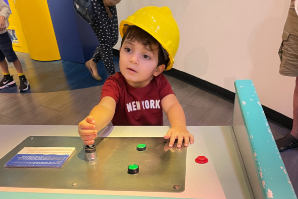 Image: A boy with a hard hat at Miami Children's Museum