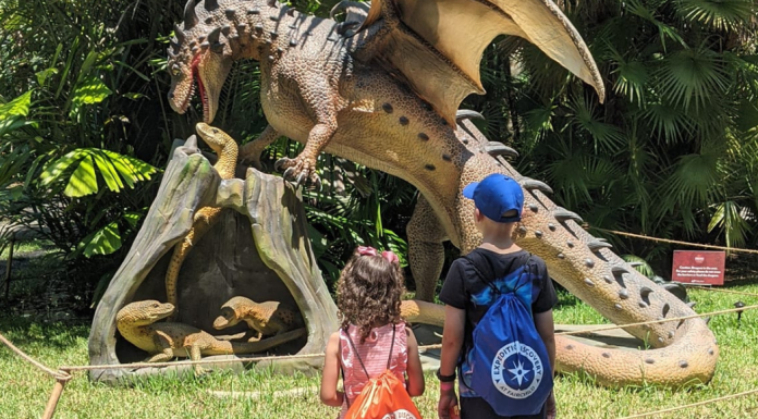 Image: Two kids enjoying the Dragons & Mythical Creatures exhibit at Fairchild Tropical Botanic Garden