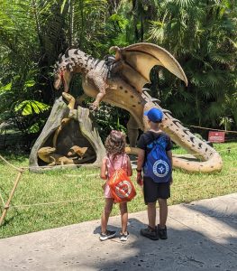 Image: Two kids looking watching an automated dragon